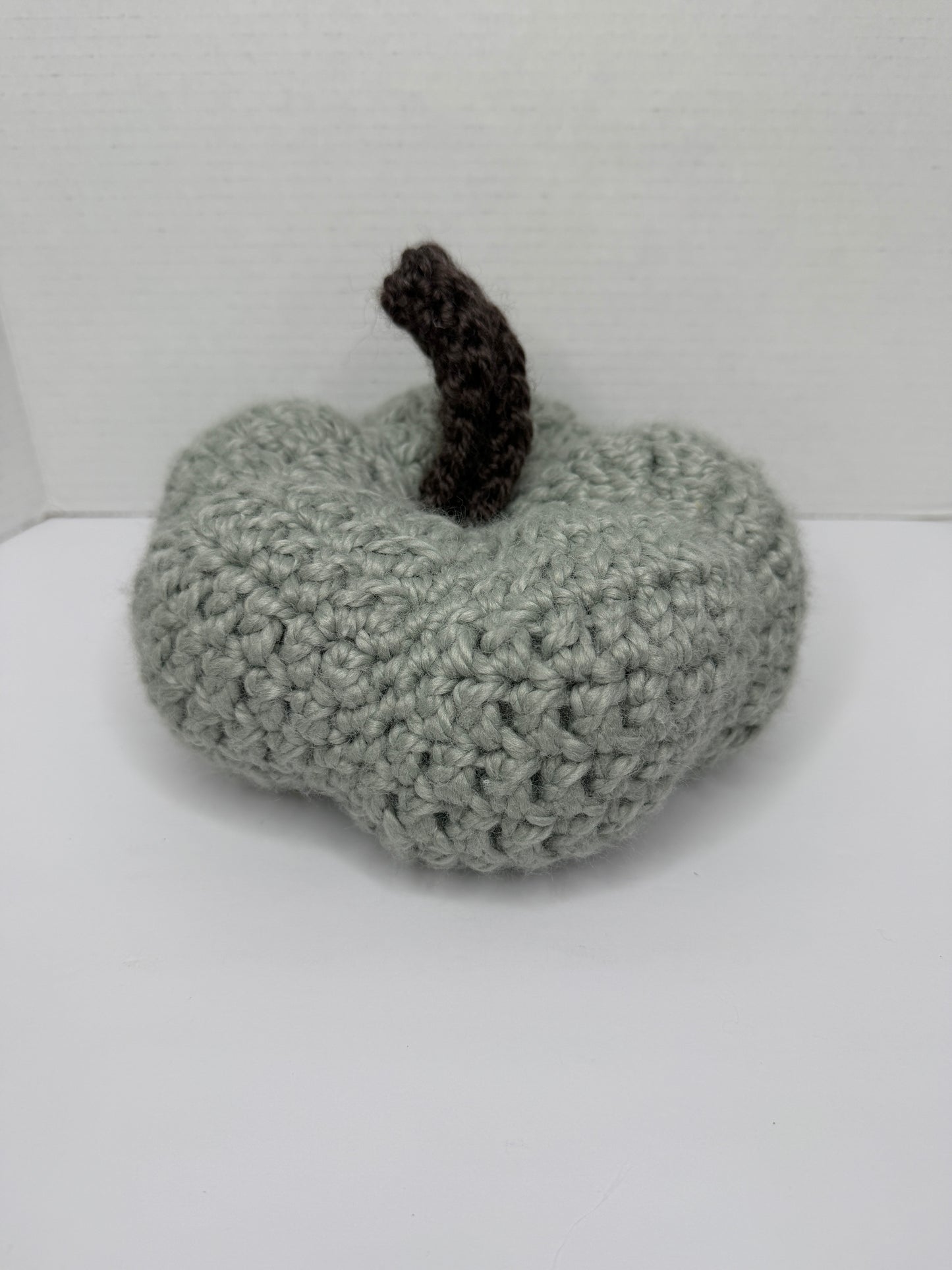 Crochet gray pumpkin on a white background