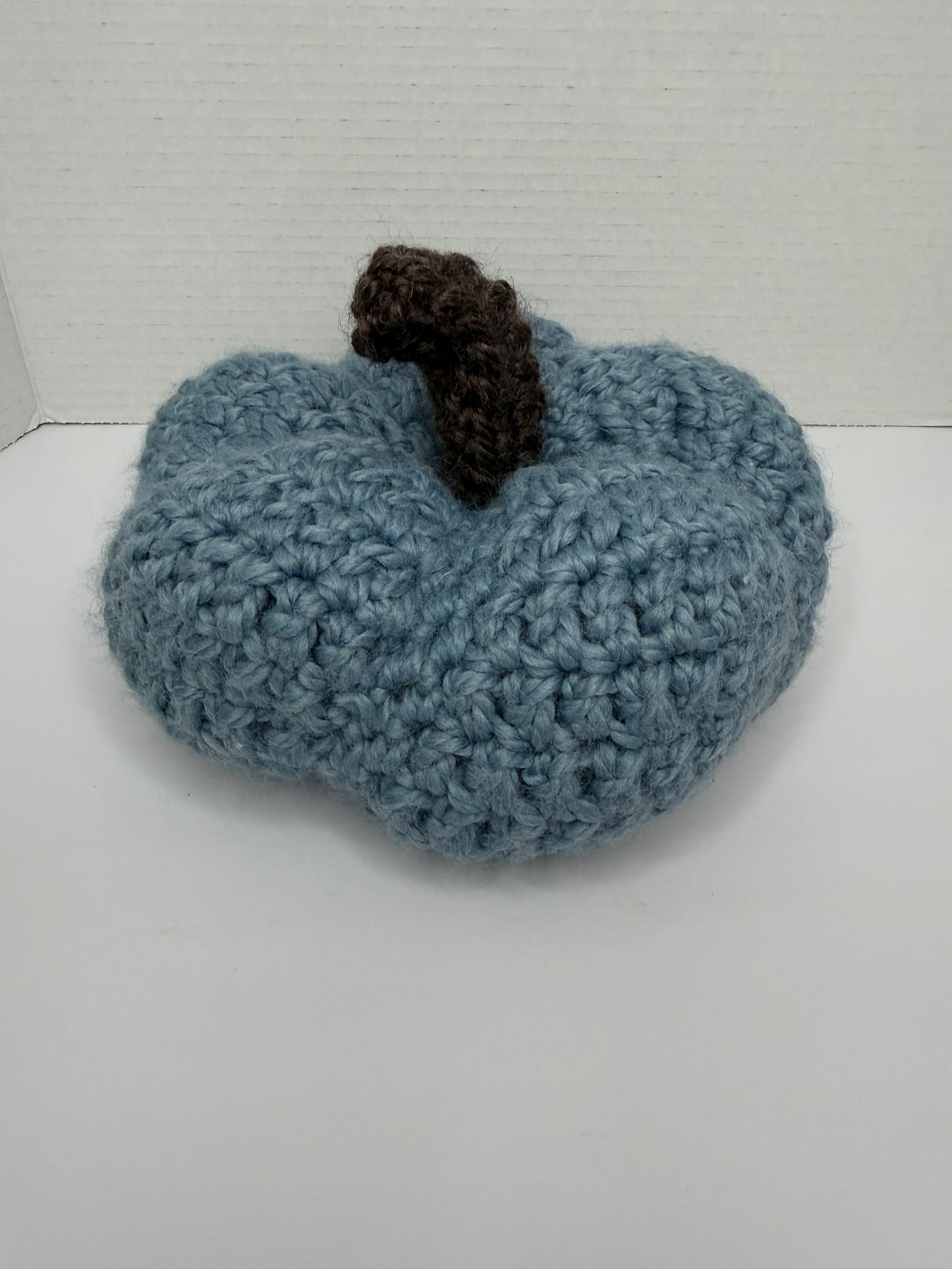 Crochet blue pumpkin on a white background