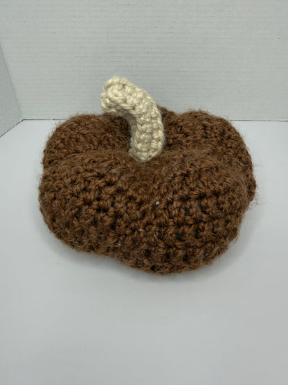 Crochet brown pumpkin on a white background