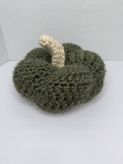 Crochet green pumpkin on a white background