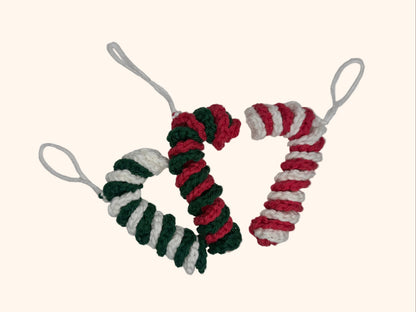 Three crochet candy cane ornaments on a white background