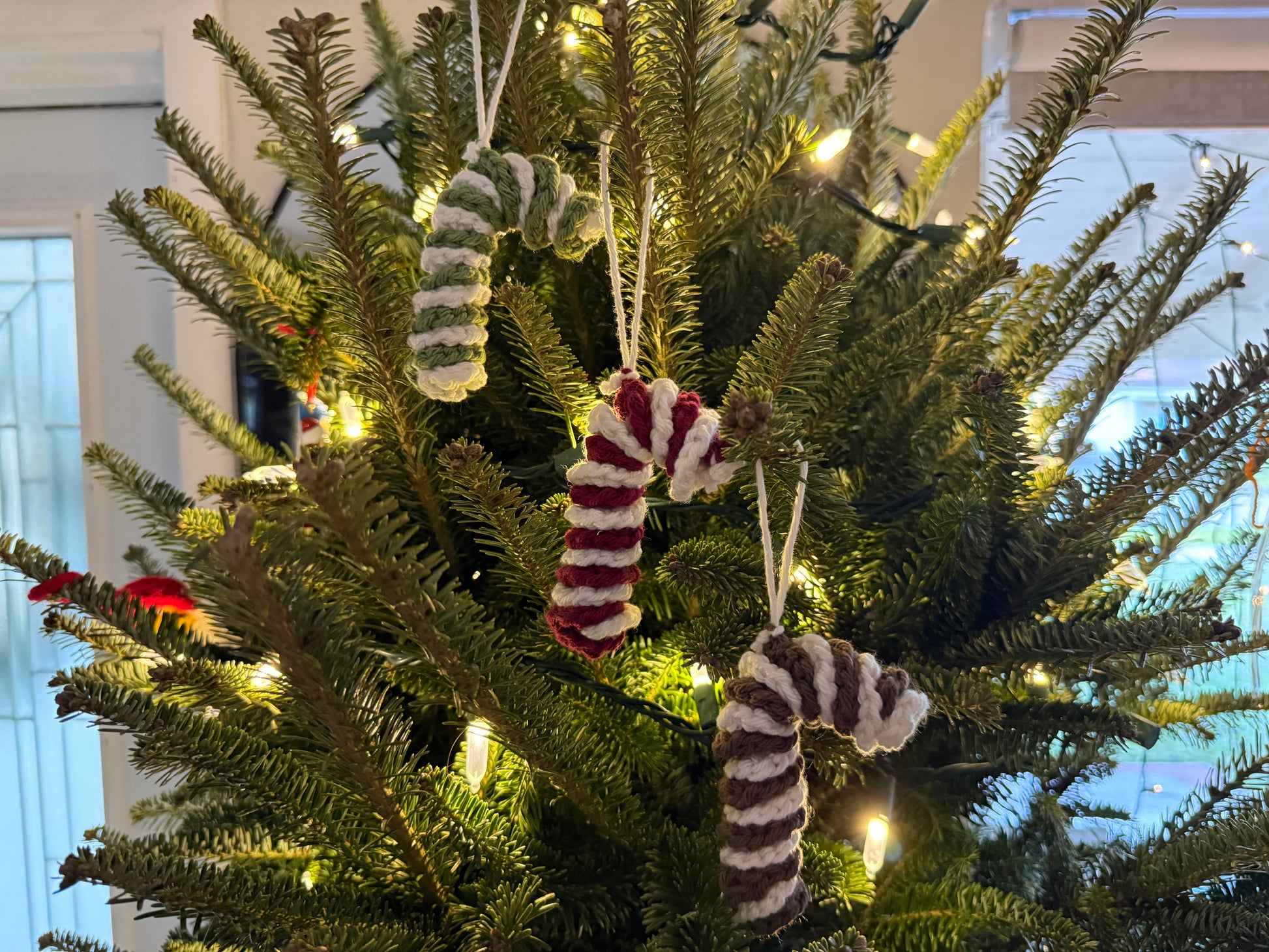 Decorative Christmas tree with candy cane ornaments and lights.