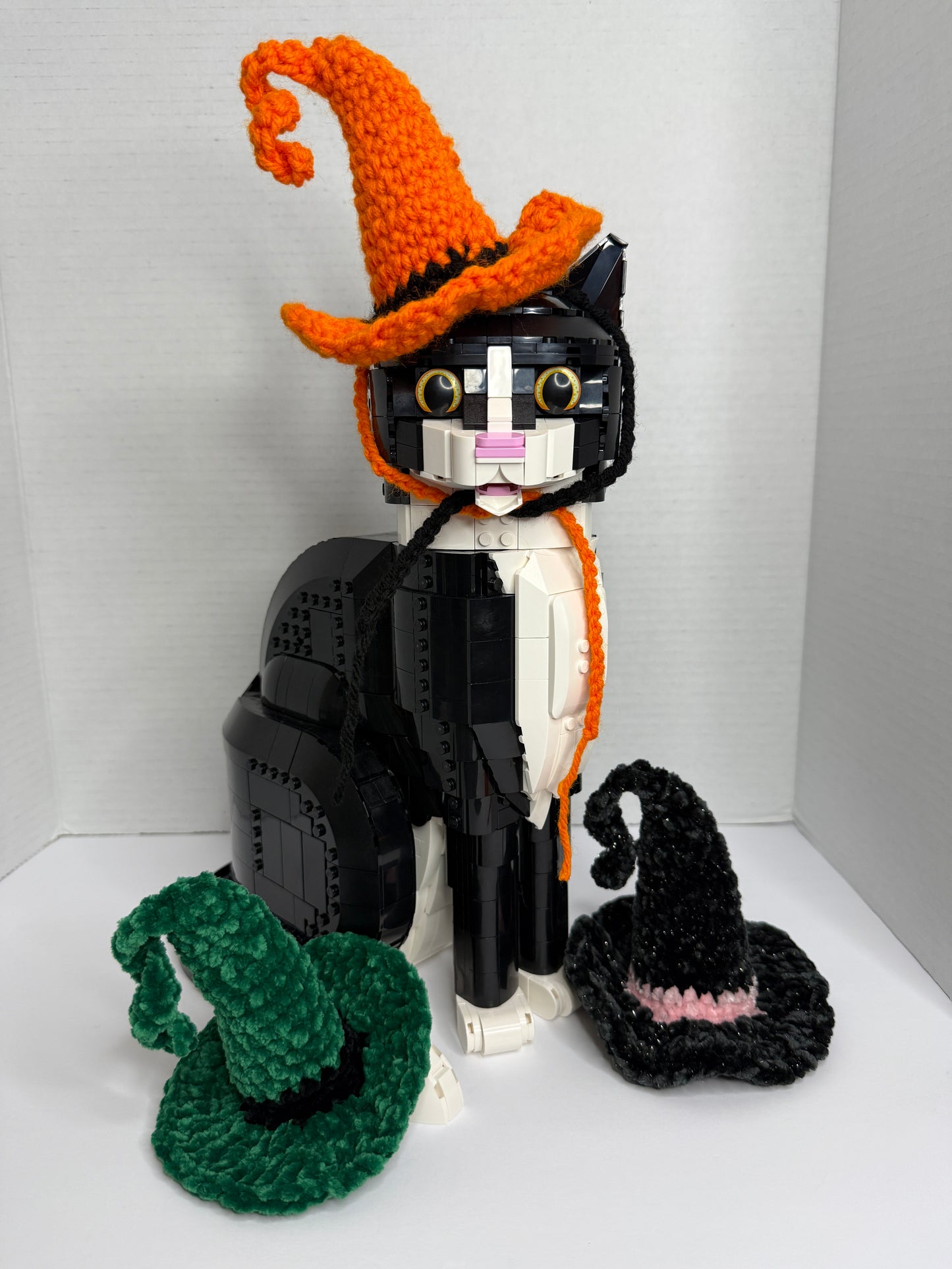 Toy cat with crochet witch hat in multiple colors
